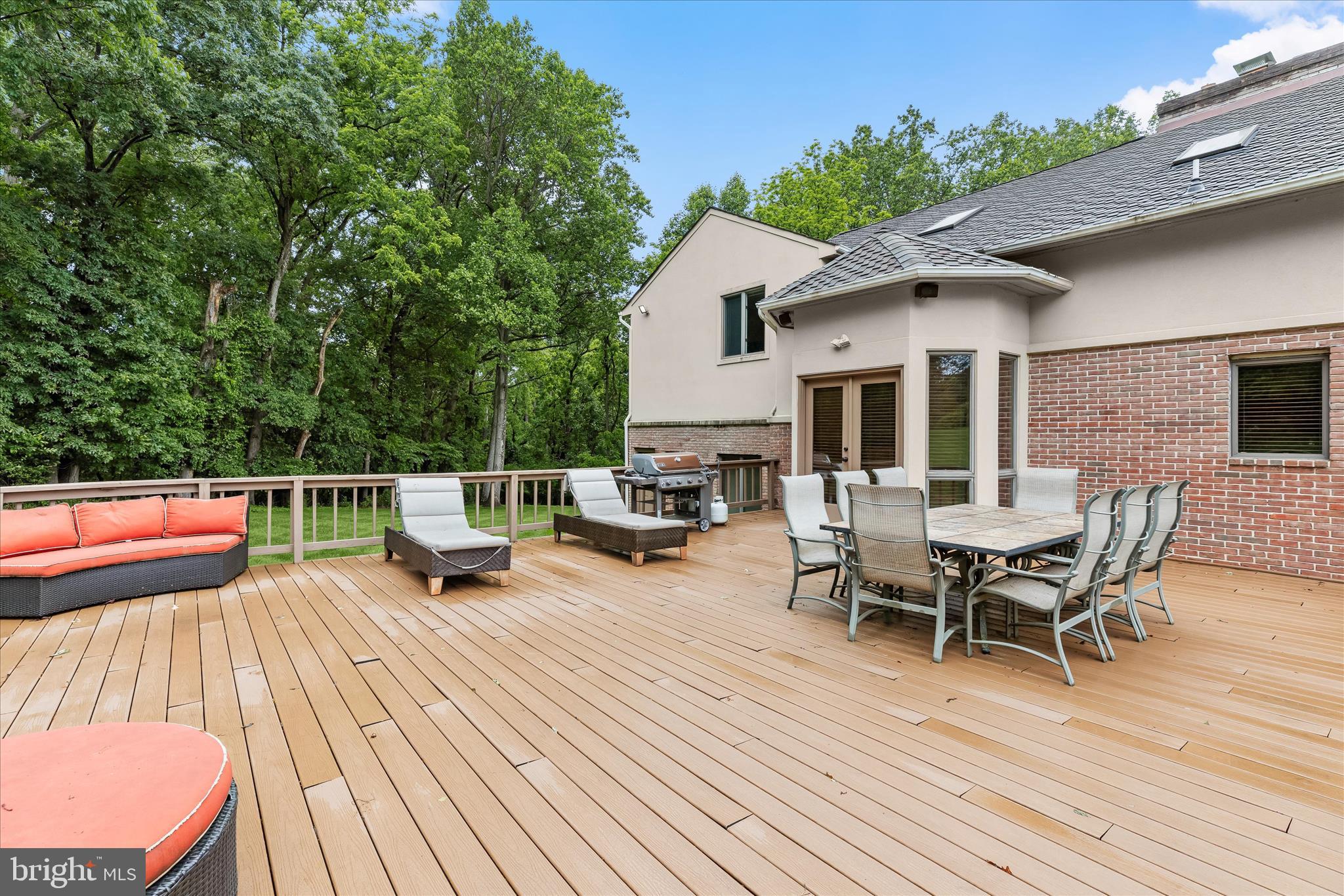 13304 Ridgewood Drive Ellicott City, MD 21042 - Photo 70 of 95 a view of a roof deck with table and chairs floor to ceiling window with wooden floor