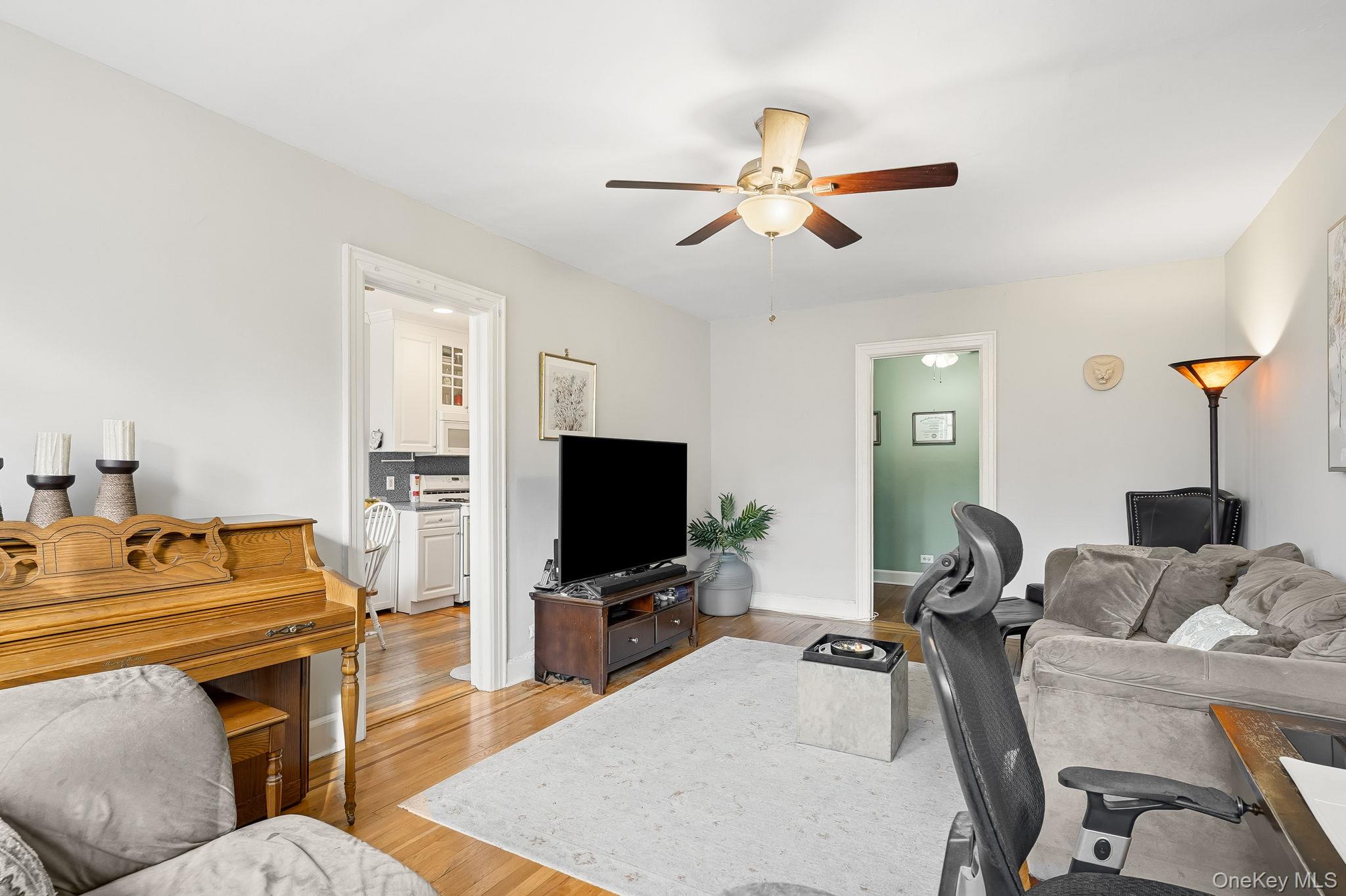 23 Old Mamaroneck Road, Unit 3L White Plains, NY 10605 - Photo 4 of 16 Living room featuring a ceiling fan and light wood-style floors