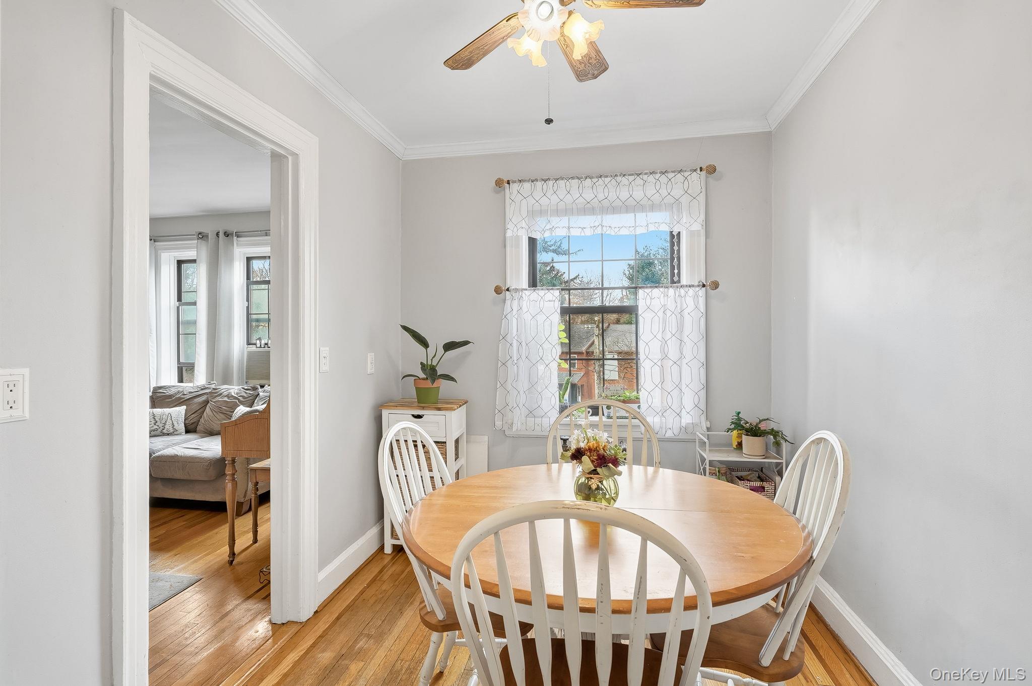 23 Old Mamaroneck Road, Unit 3L White Plains, NY 10605 - Photo 5 of 16 Dining room with ceiling fan, plenty of natural light, light wood-style floors, and ornamental molding