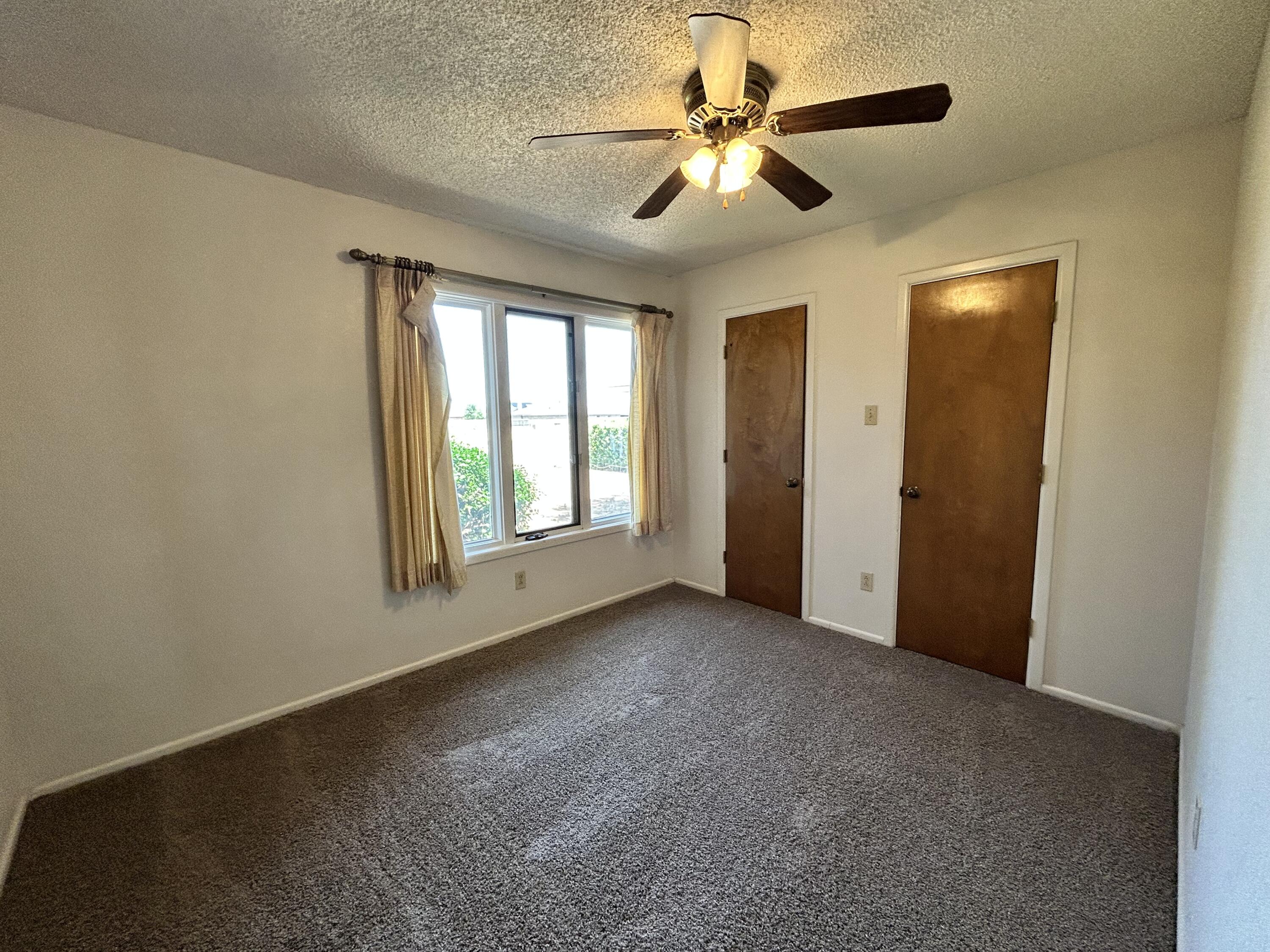 1115 80th Street, Unit A Lubbock, TX 79423 - Photo 11 of 16 an empty room with windows and fan