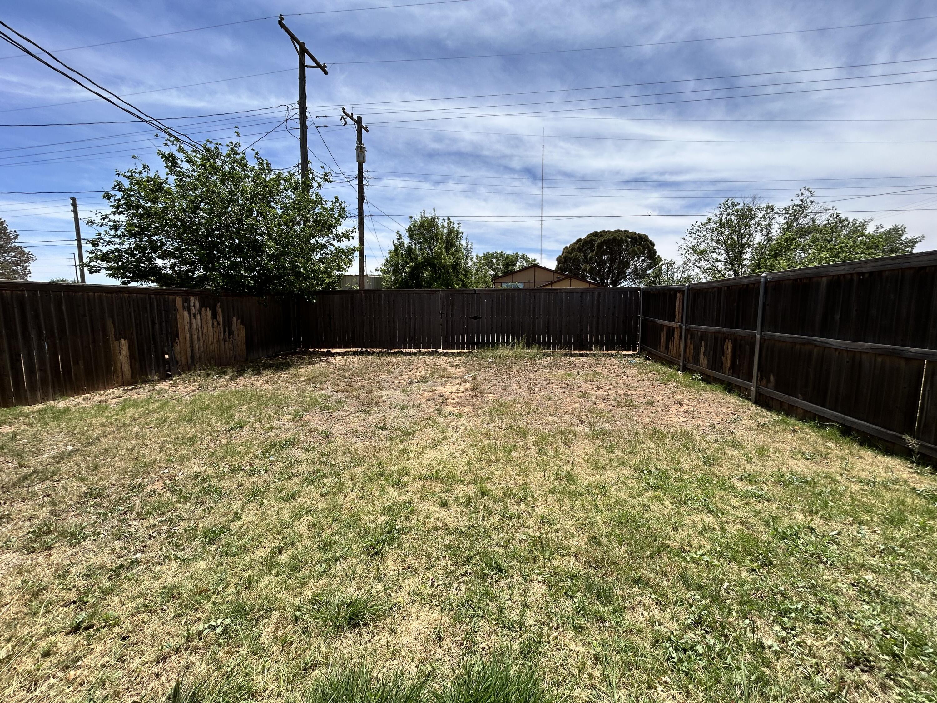 1115 80th Street, Unit A Lubbock, TX 79423 - Photo 16 of 16 a swimming pool with wooden fence