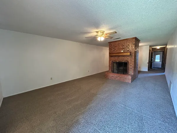 a view of empty room with a fireplace