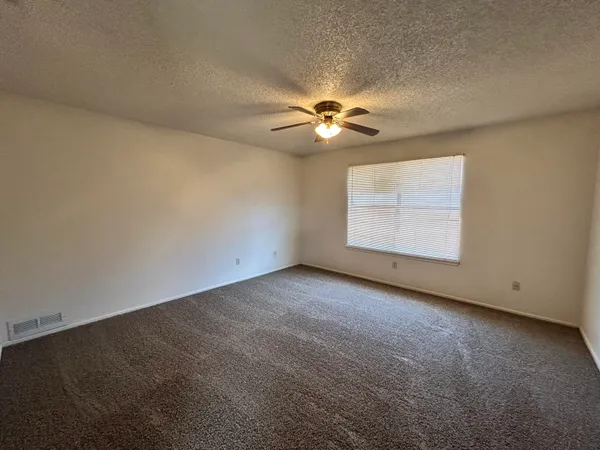 an empty room with a empty space and a ceiling fan