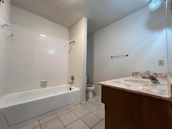 a bathroom with a bathtub sink vanity and toilet