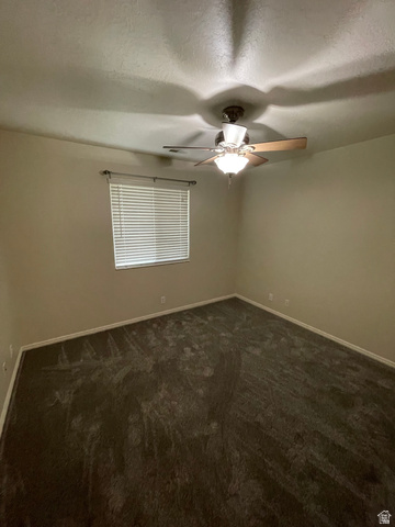 101 1501 Monroe, Unit 101 Ogden, UT 84404 - Photo 18 of 24 Spare room with dark carpet, ceiling fan, and a textured ceiling