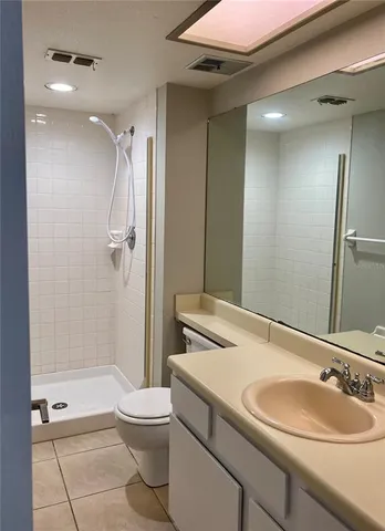 a bathroom with a sink toilet tub and shower
