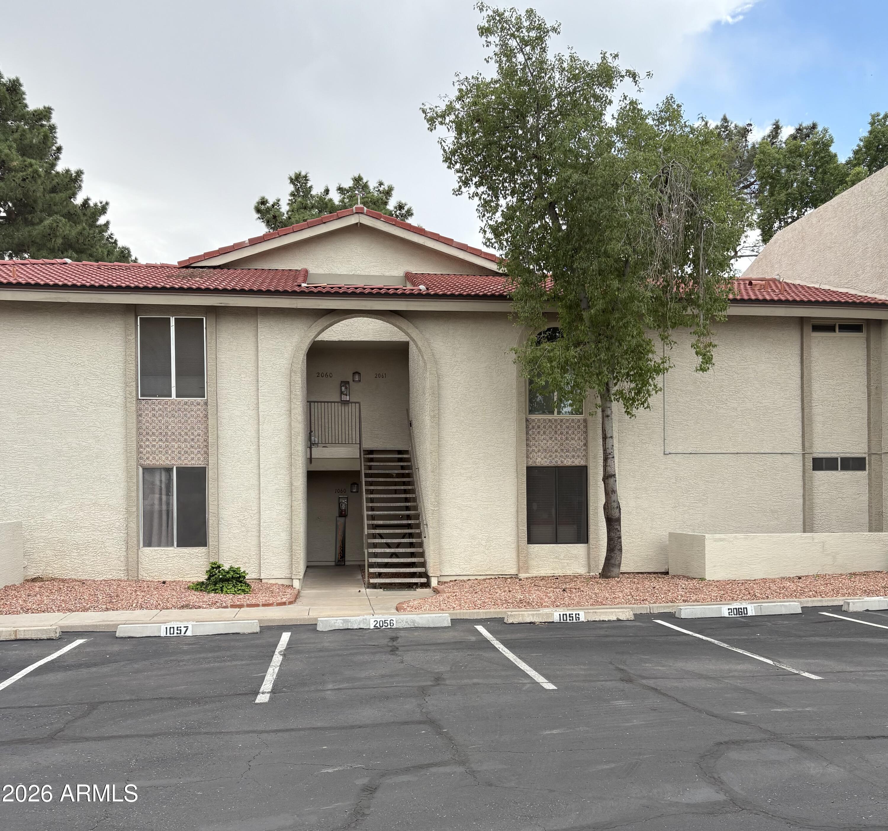10610 South 48th Street, Unit 1061 Phoenix, AZ 85044 - Photo 1 of 6 a view of a house with a yard and garage