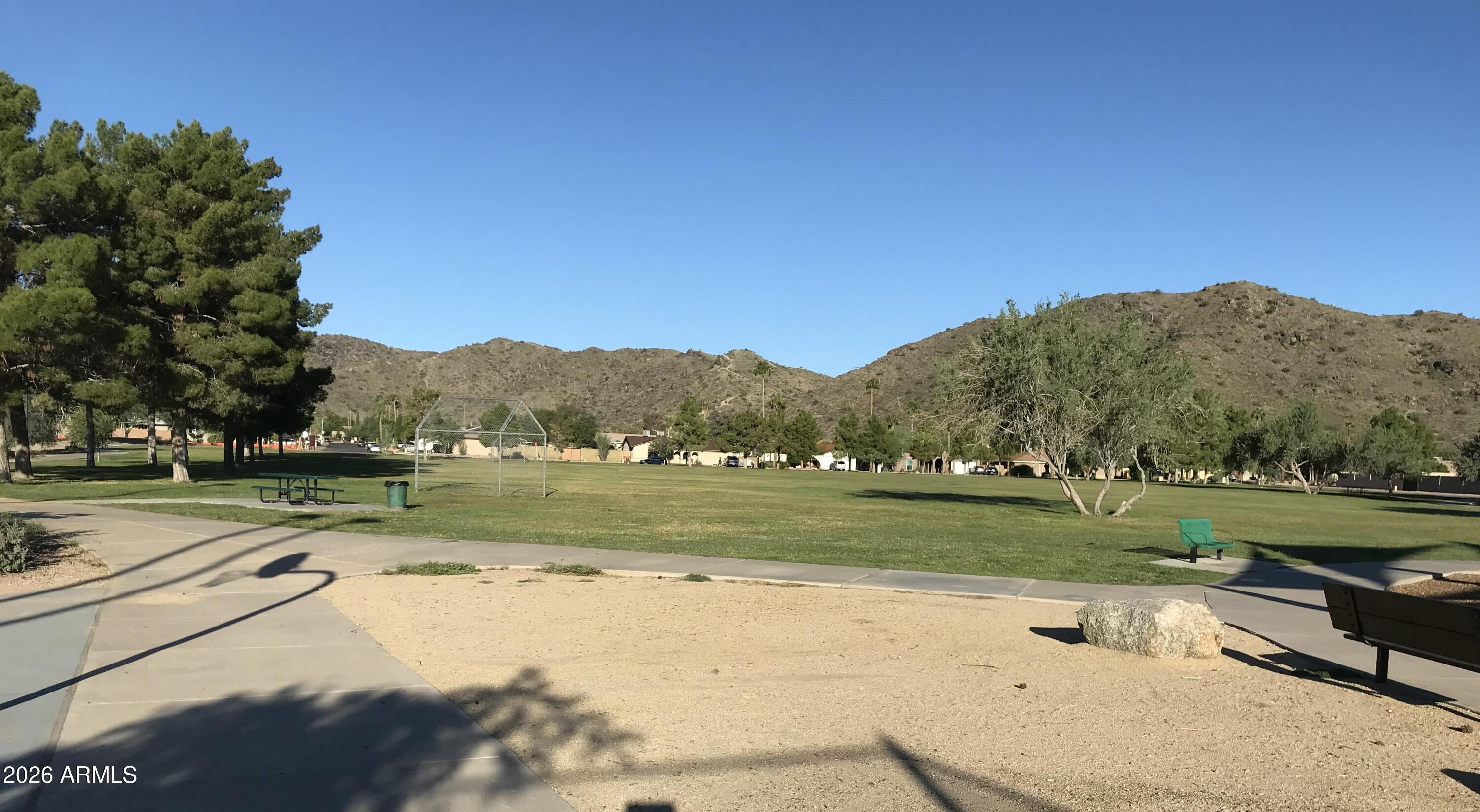 10610 South 48th Street, Unit 1061 Phoenix, AZ 85044 - Photo 3 of 6 a view of a lake with a yard