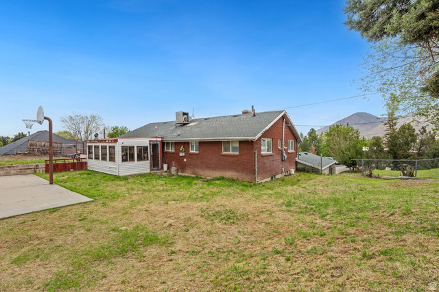 149 West 1600th Street South Mapleton, UT 84664 - Photo 40 of 44 Back of property with a sunroom and brick siding