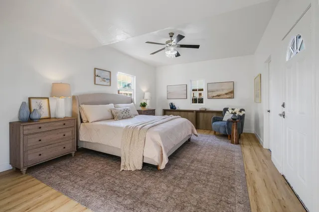 a spacious bedroom with a bed and a chandelier