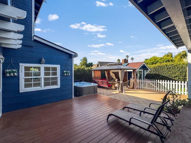 a view of a porch with furniture and a yard