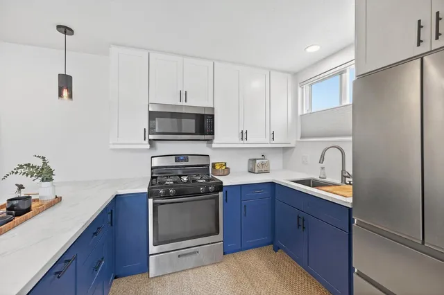 a kitchen with stainless steel appliances granite countertop a stove a sink dishwasher and a refrigerator