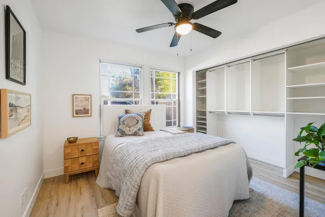 a bedroom with a bed and a chandelier