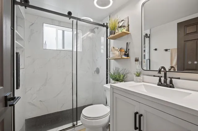 a bathroom with a sink toilet and shower