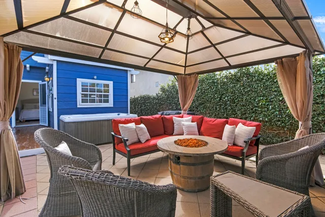 a outdoor sitting area with furniture and umbrella