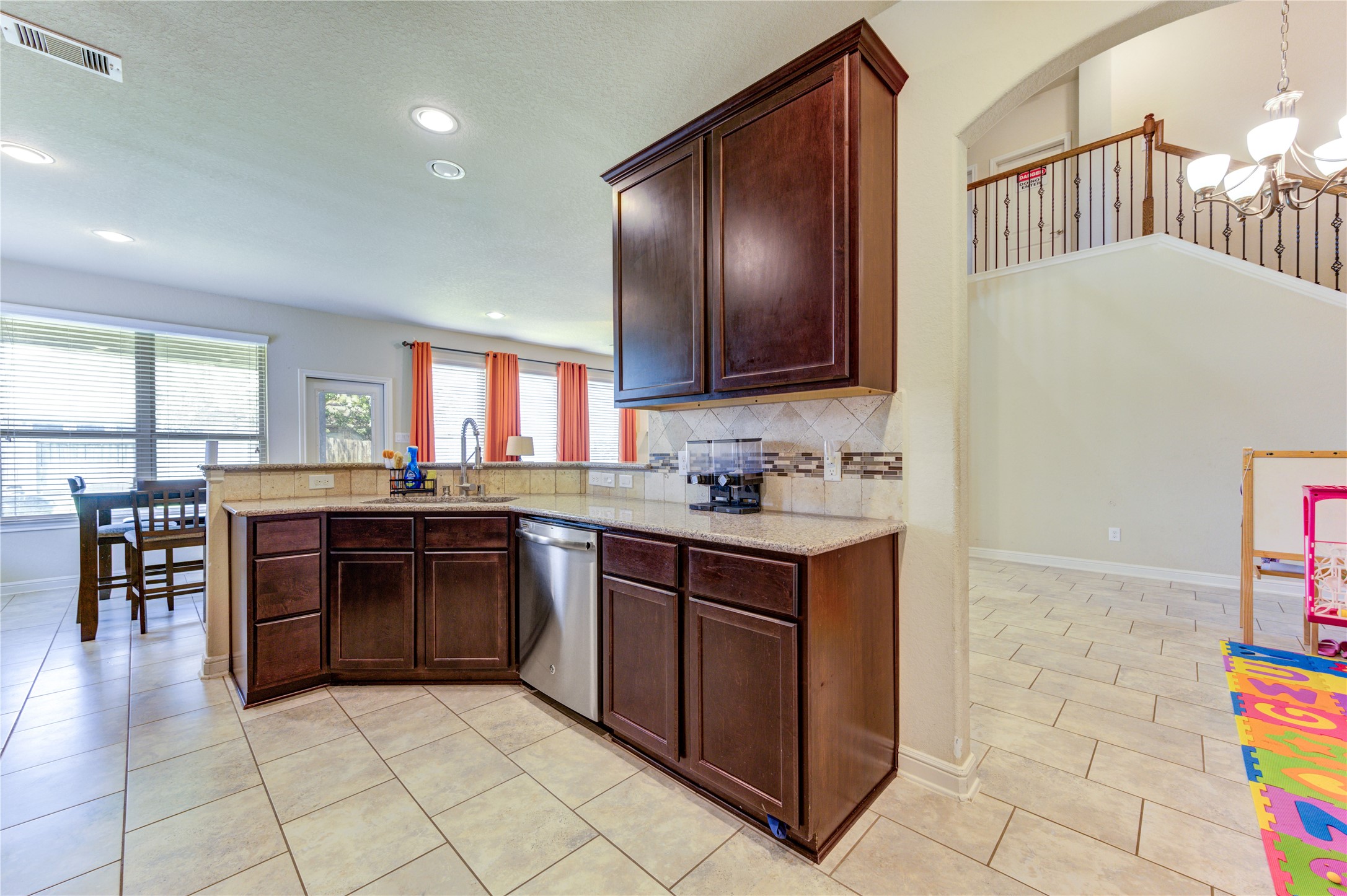 24511 Stratton Creek Drive Spring, TX 77373 - Photo 13 of 27 Open Kitchen Design – Overlooking the breakfast area and family room, this kitchen offers a spacious layout with a gas range, extensive counter space, and an open flow perfect for staying connected with family and guests.