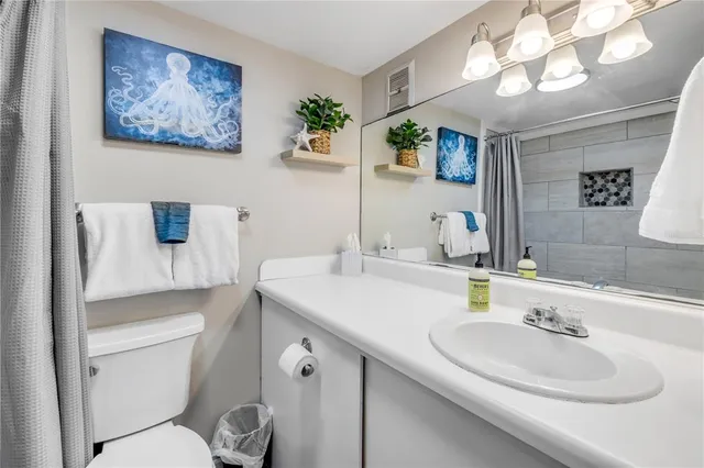 a bathroom with a toilet a sink and a mirror