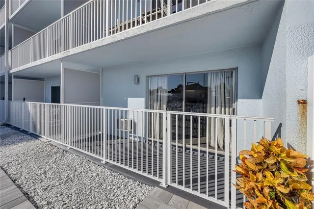 a view of a patio with a dining table and chairs