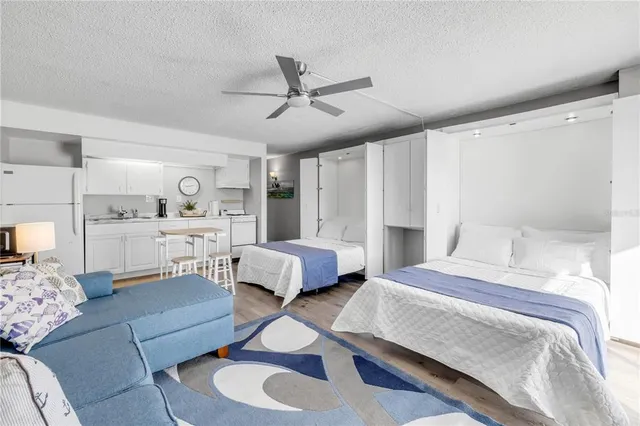 a living room with furniture and view of kitchen