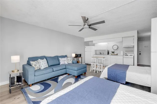 a bedroom with a bed a flat screen tv and a fireplace