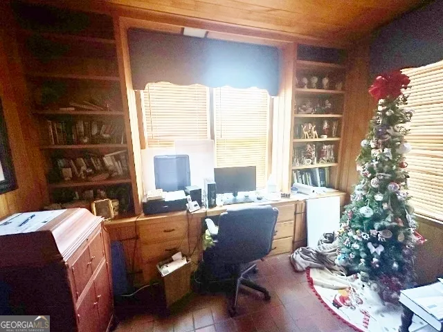 a view of a workspace with furniture and a potted plant
