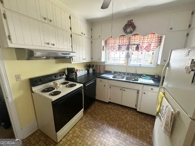 a kitchen with a stove sink and cabinets