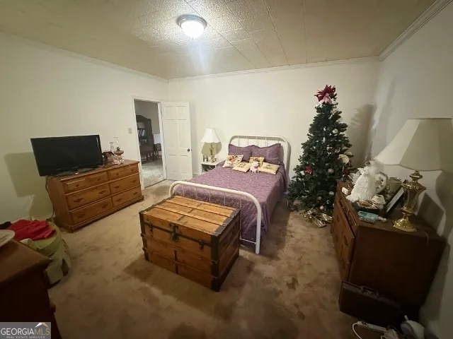 a bedroom with furniture and a flat screen tv