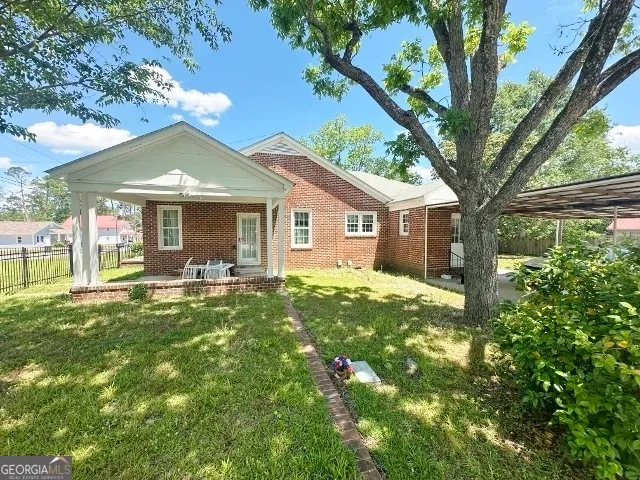 a front view of a house with a yard and porch