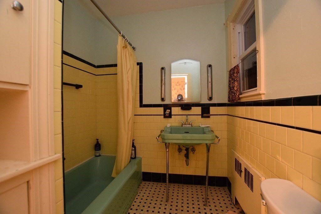230 Oakley Road Woonsocket, RI 02895 - Photo 14 of 20 a bathroom with a sink a mirror and shower