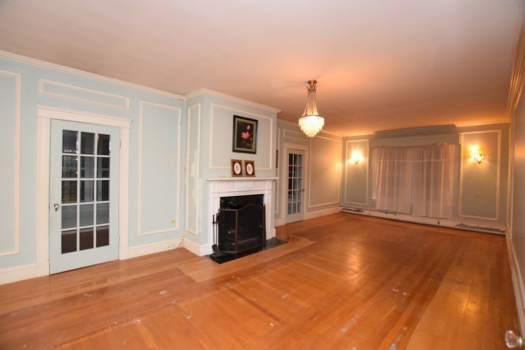 230 Oakley Road Woonsocket, RI 02895 - Photo 2 of 20 an empty room with windows and fireplace