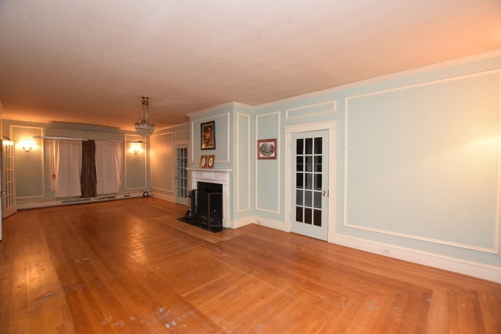 230 Oakley Road Woonsocket, RI 02895 - Photo 5 of 20 an empty room with windows and fireplace