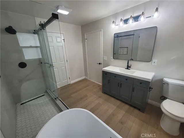 a spacious bathroom with a double vanity sink mirror and toilet