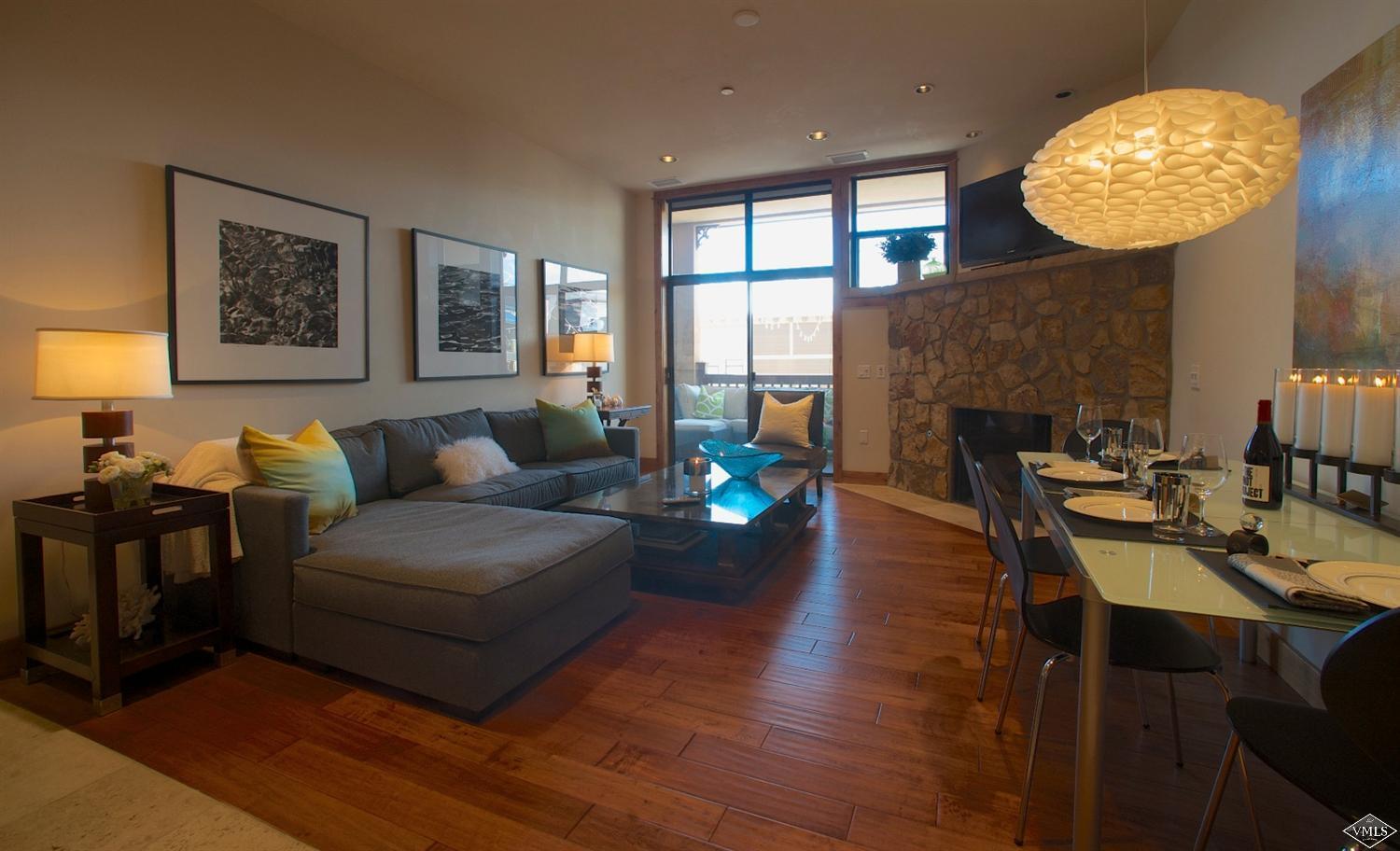 a living room with fireplace furniture and a large window