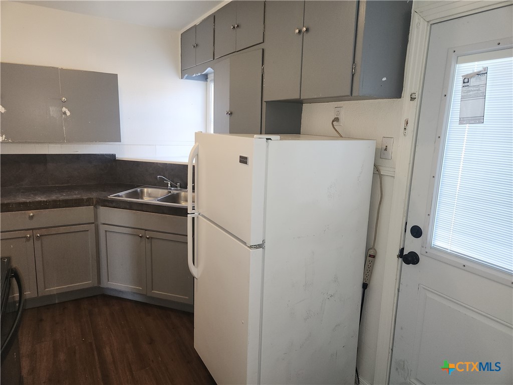 902 South 23rd Street Temple, TX 76504 - Photo 3 of 8 a kitchen with a refrigerator and a stove