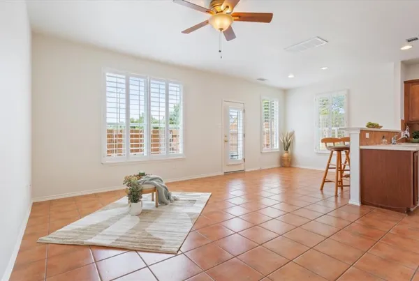 a view of a livingroom with workspace and a window
