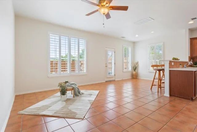 a view of a livingroom with workspace and a window