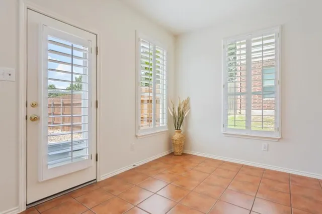 a kitchen with a sink a refrigerator and cabinets