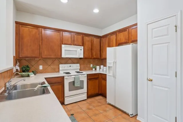 a kitchen with a sink cabinets and appliances