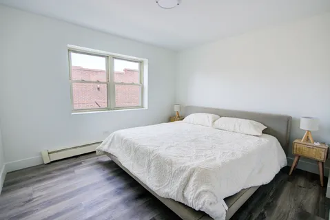 a bed sitting in a bedroom next to a window
