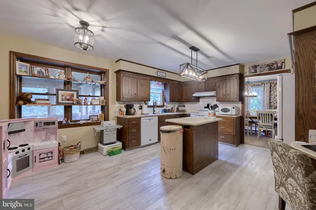 a kitchen with cabinets and wooden floor