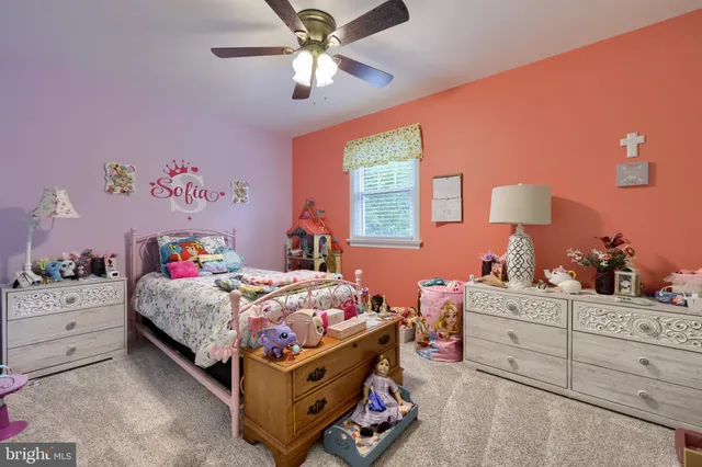 a bedroom with a bed and a dresser in it