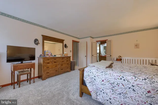 a bedroom with a bed and flat screen tv