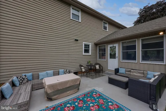 a backyard of a house with outdoor seating