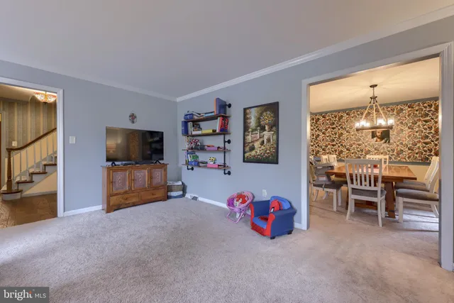 a view of a livingroom with furniture and a flat screen tv