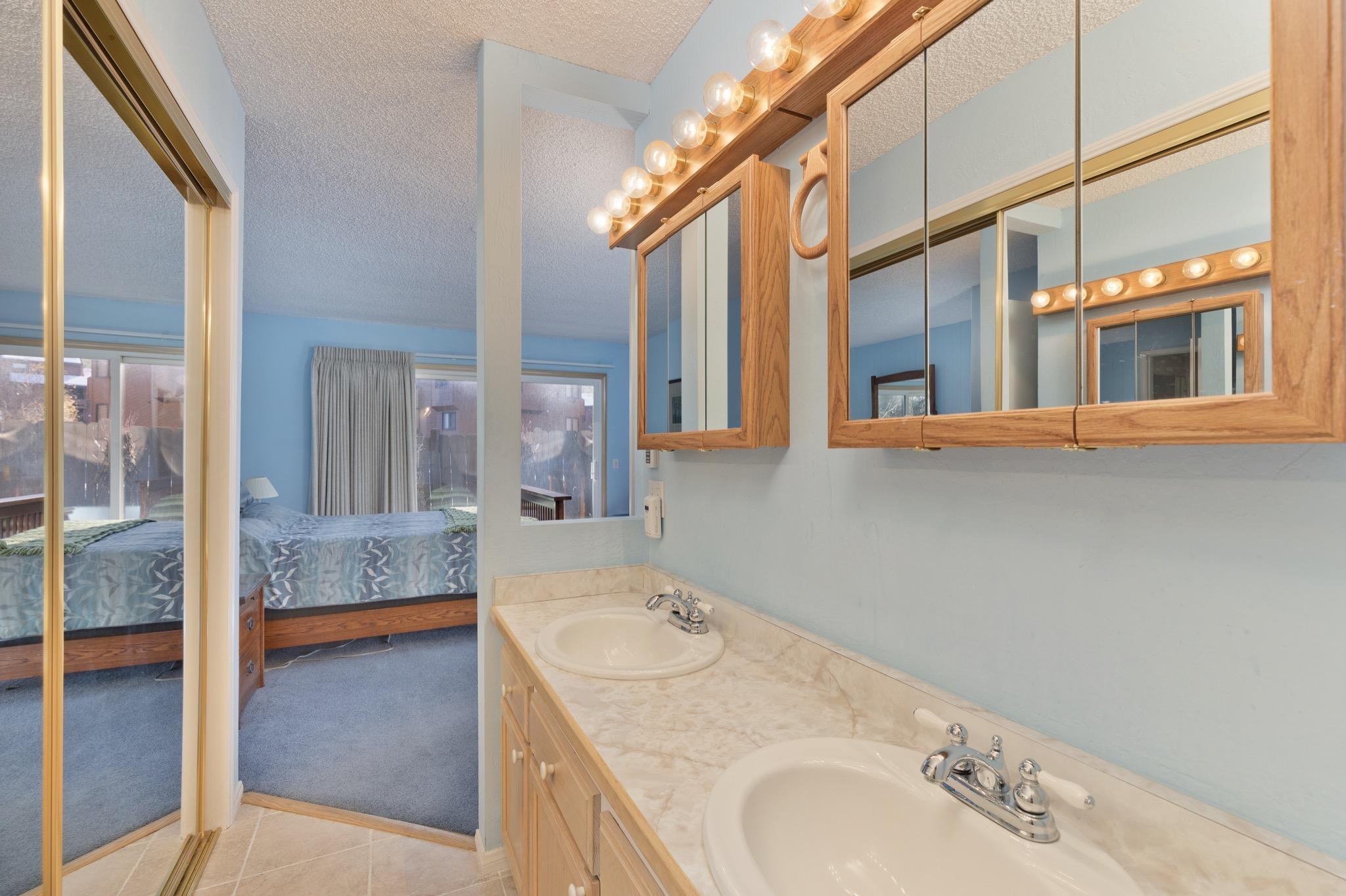 3251 Chateau Road, Unit 40 Mammoth Lakes, CA 93546 - Photo 20 of 31 Bathroom with double vanity, ensuite bath, a textured ceiling, light carpet, and light tile patterned flooring