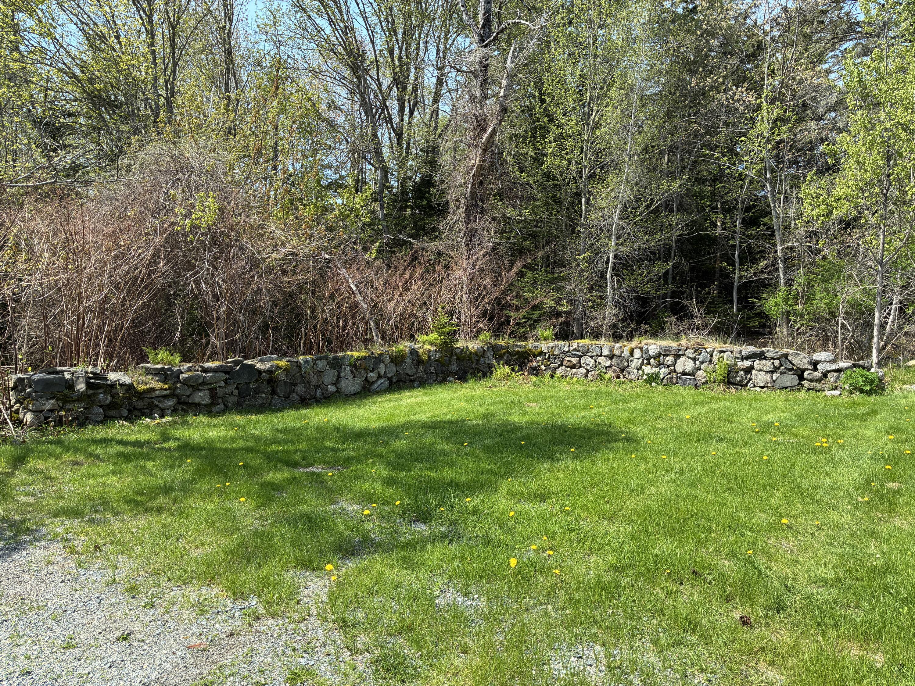 707 Newbury Neck Road Surry, ME 04684 - Photo 39 of 40 Stone wall next to garage.