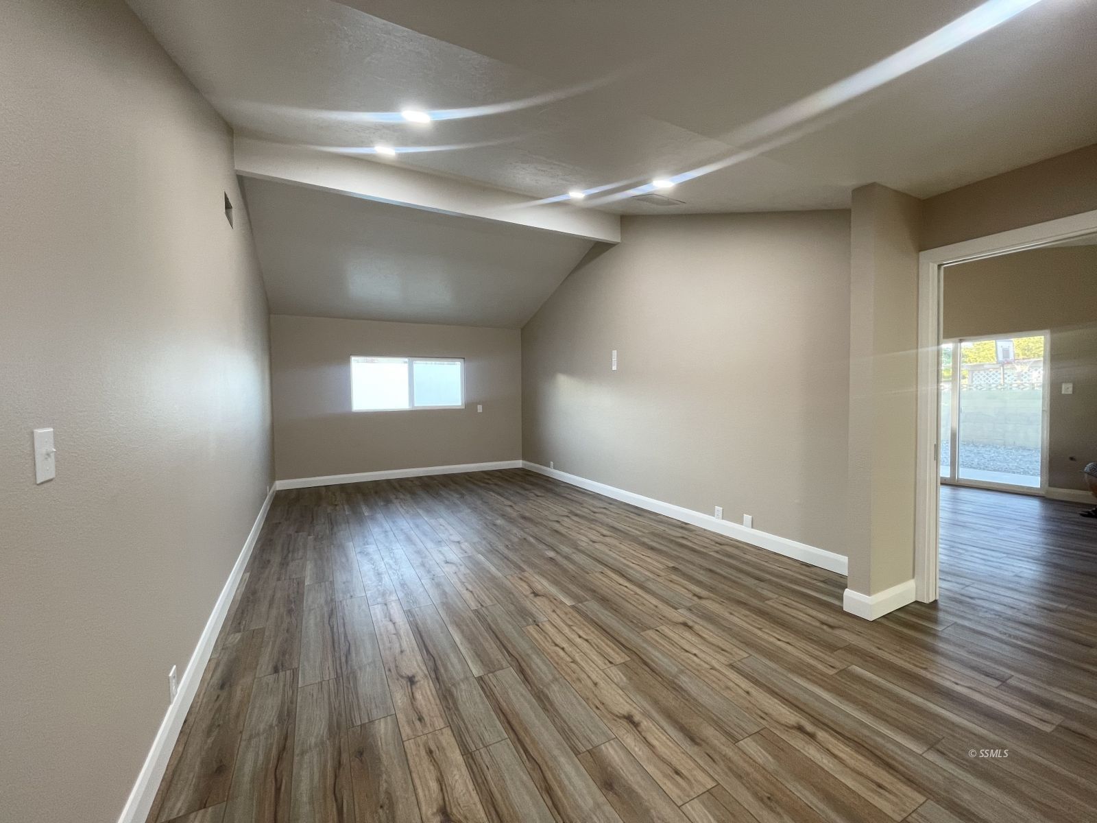 1031 North Sierra View Street Ridgecrest, CA 93555 - Photo 4 of 33 wooden floor in an empty room with a window
