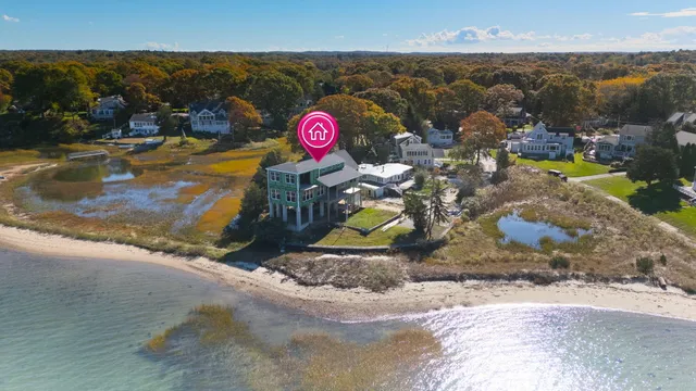 an aerial view of a houses with a lake view