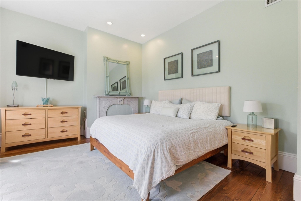 419 Main Street Boston, MA 02129 - Photo 22 of 41 a bedroom with a bed and a flat screen tv