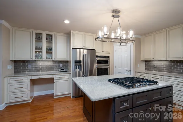 a kitchen with a stove and refrigerator